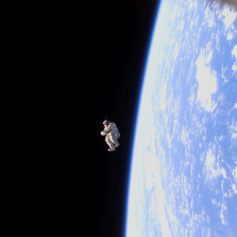 Earth - 5 Apollo Astronaut James B. Irwin, lunar module pilot, works at the Lunar Roving Vehicle during the first Apollo 15 lunar surface extravehicular activity (EVA) at the Hadley-Apennine landing site. The shadow of the Lunar Module "Falcon" is in the foreground. This view is looking northeast, with Mount Hadley in the background. This photograph was taken by astronaut David R. Scott, commander. Image Credit: NASA