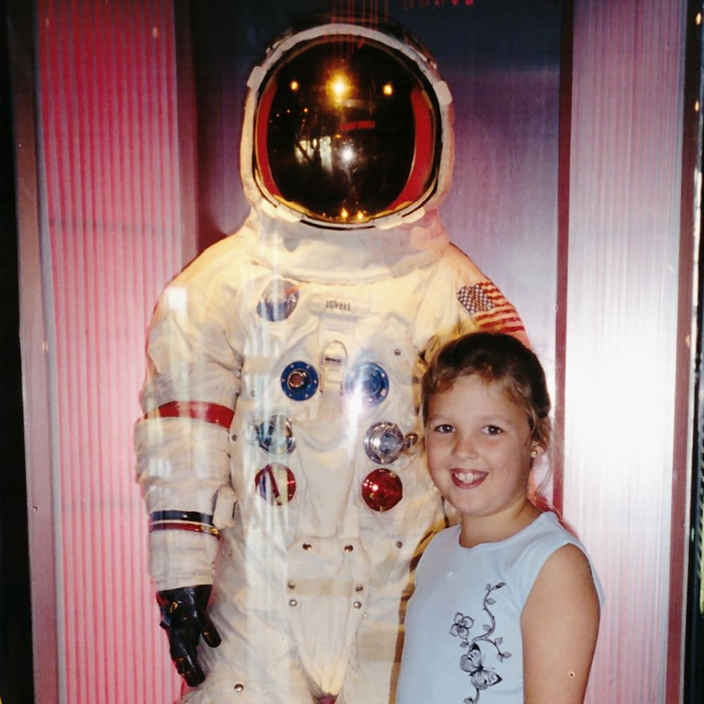 Zoe -1 Apollo Astronaut James B. Irwin, lunar module pilot, works at the Lunar Roving Vehicle during the first Apollo 15 lunar surface extravehicular activity (EVA) at the Hadley-Apennine landing site. The shadow of the Lunar Module "Falcon" is in the foreground. This view is looking northeast, with Mount Hadley in the background. This photograph was taken by astronaut David R. Scott, commander. Image Credit: NASA