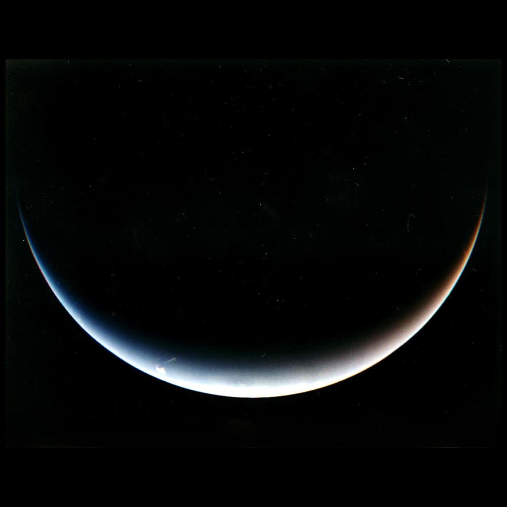 Neptune-1 Apollo Astronaut James B. Irwin, lunar module pilot, works at the Lunar Roving Vehicle during the first Apollo 15 lunar surface extravehicular activity (EVA) at the Hadley-Apennine landing site. The shadow of the Lunar Module "Falcon" is in the foreground. This view is looking northeast, with Mount Hadley in the background. This photograph was taken by astronaut David R. Scott, commander. Image Credit: NASA